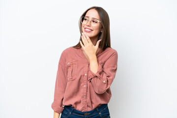 Young pretty caucasian woman isolated on white background looking up while smiling