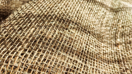 Natural fabric texture, frame and background of burlap. Rough crumpled burlap background. Selective and partial focus