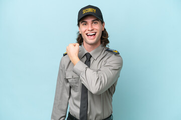 Young safeguard man isolated on blue background celebrating a victory