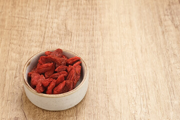 Goji berries on small bowl. Healthy food concept. Copy space
