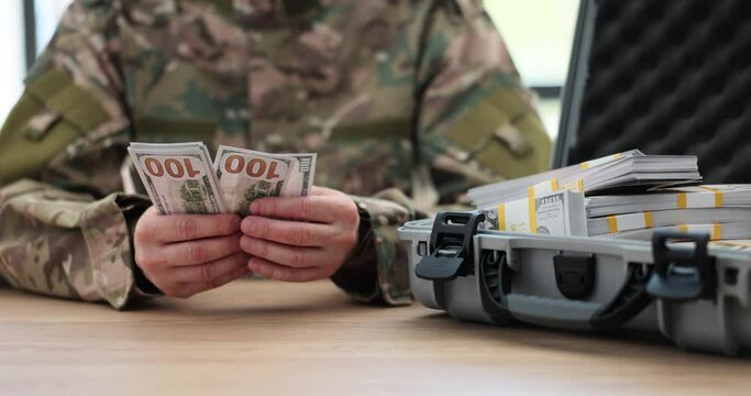 Army soldier counting million dollar money. Illegal earnings in war and sale of weapons