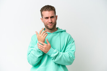 Young handsome caucasian man isolated on white background suffering from pain in hands