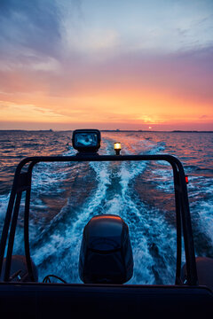 Motor of boat on sea at sunset
