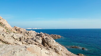 Fototapeta na wymiar Nature's Harmony: An Aerial View of Rocky Cliffs, Endless Seascape and a Solitary Boat off the Shores of Capu di Fenu, Bonifacio, Corsica