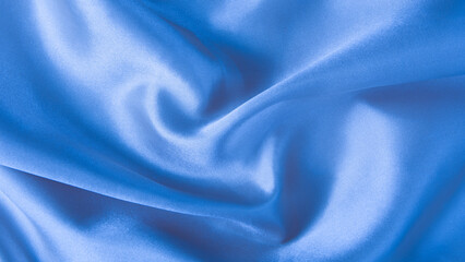 Abstract blue silk fabric texture background. Creases of satin	
