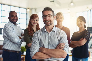 Happy businessman, portrait and arms crossed in leadership, management or CEO team at the office. Confident business people or professional standing with smile for teamwork or about us at workplace