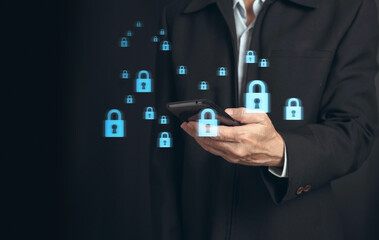 Cybersecurity and privacy concepts to protect data..Businessman hand select the lock icon and internet  network technology on smart phone device with virtual screen interfaces.