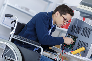 disabled worker in wheelchair checkin the voltage