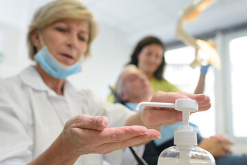 female dentist cleaning hands