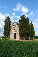 Fototapeta na wymiar View on the Vitaleta Chapel and the surrounding hills of the Orcia Valley near San Quirico d'Orcia