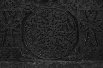 christianity Armenian khachkar. carved cross. stone background. Abstract fractal mandala pattern....