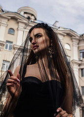 Obraz premium a woman in a Sicilian Italian look in a black dress