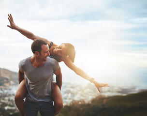 Travel, happy couple with piggyback ride and mountain outdoors with lens flare. Sunshine or mockup...