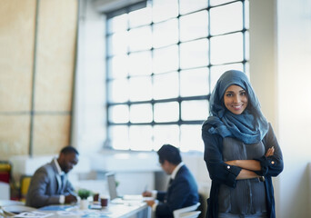 Muslim, business woman and portrait in office with a smile, hijab and arms crossed for career...