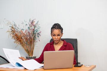 beautiful young african lady busy with work in her office