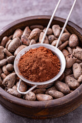 Ground cocoa and beans put on a wooden plate