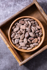 Whole cocoa beans placed on the wooden tray