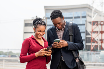 young african business people checking their phone outdoor