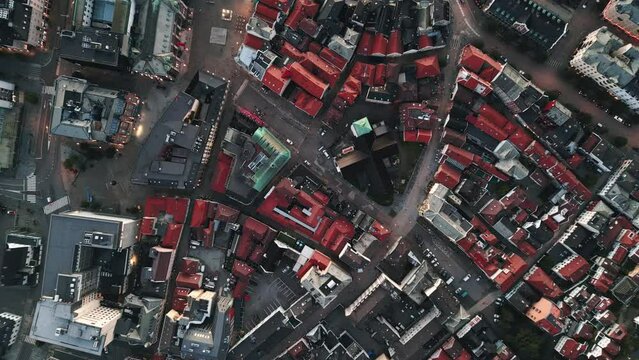 Top fixed and slowly descending aerial view over colorful rooftops of Bergen, Norway. Peaceful small town atmosphere, residential area footage concept.