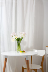 Spring bouquet tulips on white table indoor