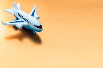 Airplane on orange background, flat lay, travel concept