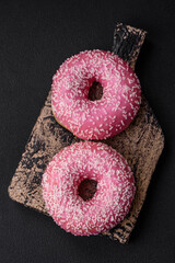 Delicious fresh sweet donuts in pink glaze with strawberry filling