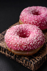 Delicious fresh sweet donuts in pink glaze with strawberry filling
