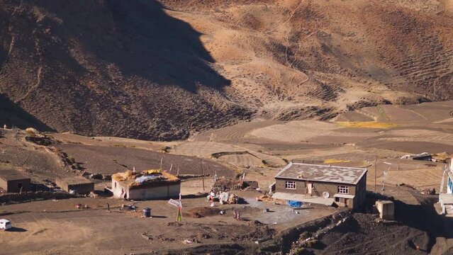 Traditional houses on the mountains at World's highest village by motorable roads in Komic village at Spiti Valley, Himachal Pradesh, India. Traditional Himachali houses with dry grass on their roof. 