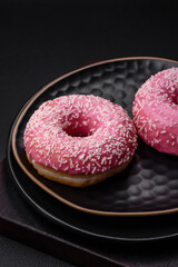 Delicious fresh sweet donuts in pink glaze with strawberry filling