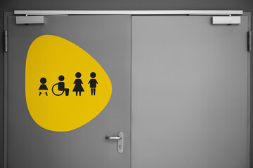 Public toilet sign with symbols on door