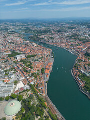 Obraz premium Aerial view of the Douro River in Porto. Aerial drone view of the city of Porto in Lisbon, the image includes bridges, riverside and the typical houses of the city, fado