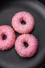 Delicious fresh sweet donuts in pink glaze with strawberry filling