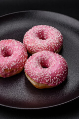 Delicious fresh sweet donuts in pink glaze with strawberry filling