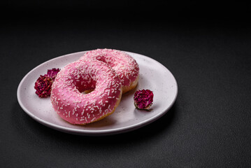Delicious fresh sweet donuts in pink glaze with strawberry filling