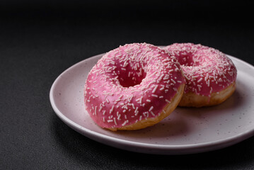 Delicious fresh sweet donuts in pink glaze with strawberry filling
