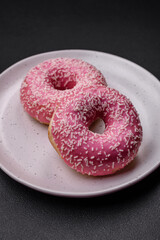 Delicious fresh sweet donuts in pink glaze with strawberry filling