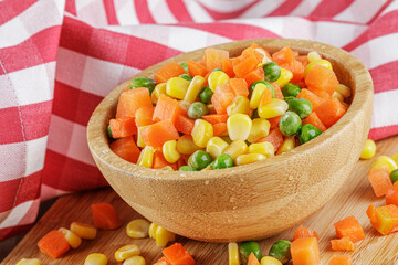 Close up of a wooden bowl of delicious mixed vegetables