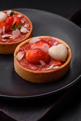 Delicious fresh sweet tartlets with strawberries and coconut flakes