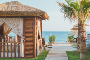 one straw pavilions on the beach by the sea, the concept of rest and vacation