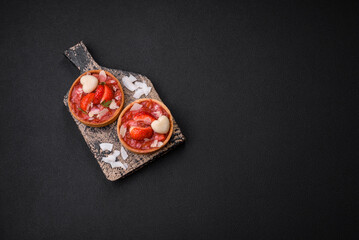 Delicious fresh sweet tartlets with strawberries and coconut flakes