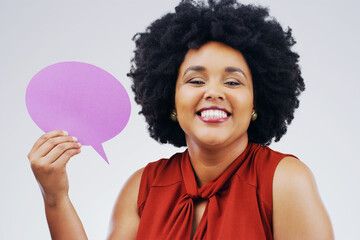 Happy woman, portrait smile and holding speech bubble for question, FAQ or social media against a white studio background. Female person smiling with afro or sign for comment, message or mockup space
