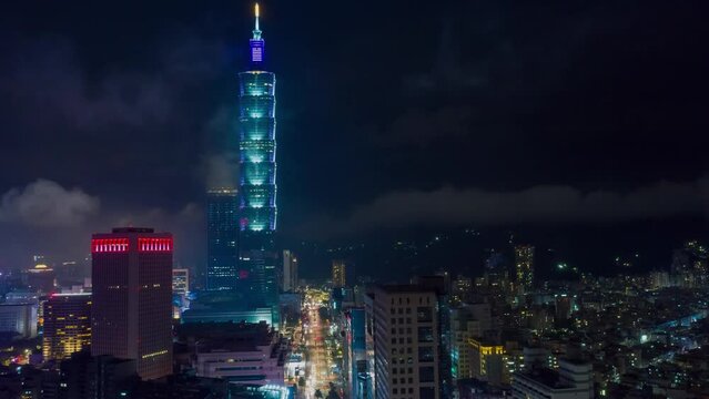 TAIWAN, TAIPEI - MAY, 2023: Aerial drone timelapse hyperlapse view of the busy traffic in city downtown streets at rush hour, with 101 Tower among crowded buildings in Xinyi District, Taipei