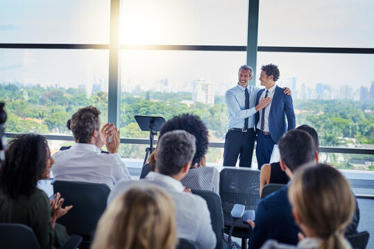 Professional, presentation and applause during a seminar at the workplace with people in the audience. Business, employees and congratulations during conference for awards in career at the office.