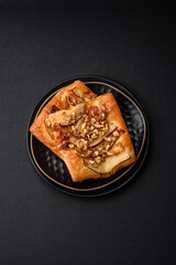 Delicious fresh sweet pie or pizza with pear, brie cheese, honey and nuts