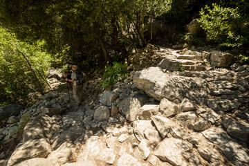 Hiker Looks Out To The Left After Passing Rocky Switchback Along Yosemite Falls Trail
