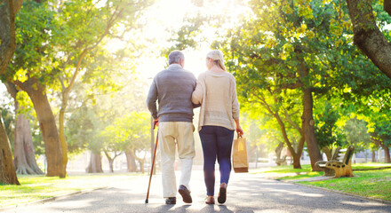 Back, woman and senior father in a park, walking and care with fresh air, bonding and loving...