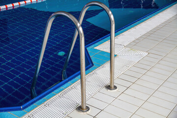 Handrails and steps for safe descent into the pool.