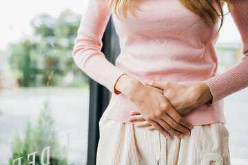 Sad Woman Stomach Ache from menstruation. young female unhappy unwell sick ill hand holding on stomach suffers pain at home, Abdomen bloating and Chronic gastritis concept