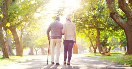 Senior man, daughter and cane outdoor in a park while walking together for support, love and care....