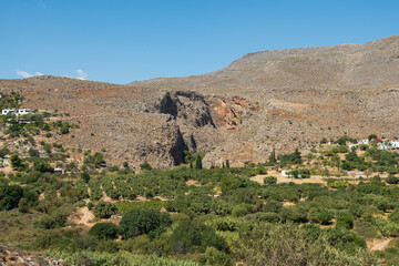 Fototapeta na wymiar Kato Zakros, panoramic view on entrance of Gorge of the Dead and beautiful valley of olive groves. Lasithi Province, Crete Greece 